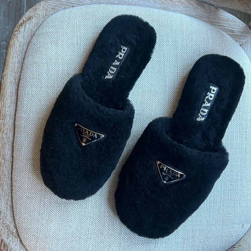 Prada logo plaque shearling slippers